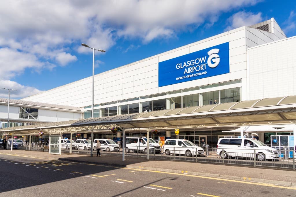 Glasgow Airport terminal with Glasgow Airport signage and Proud to serve Scotland